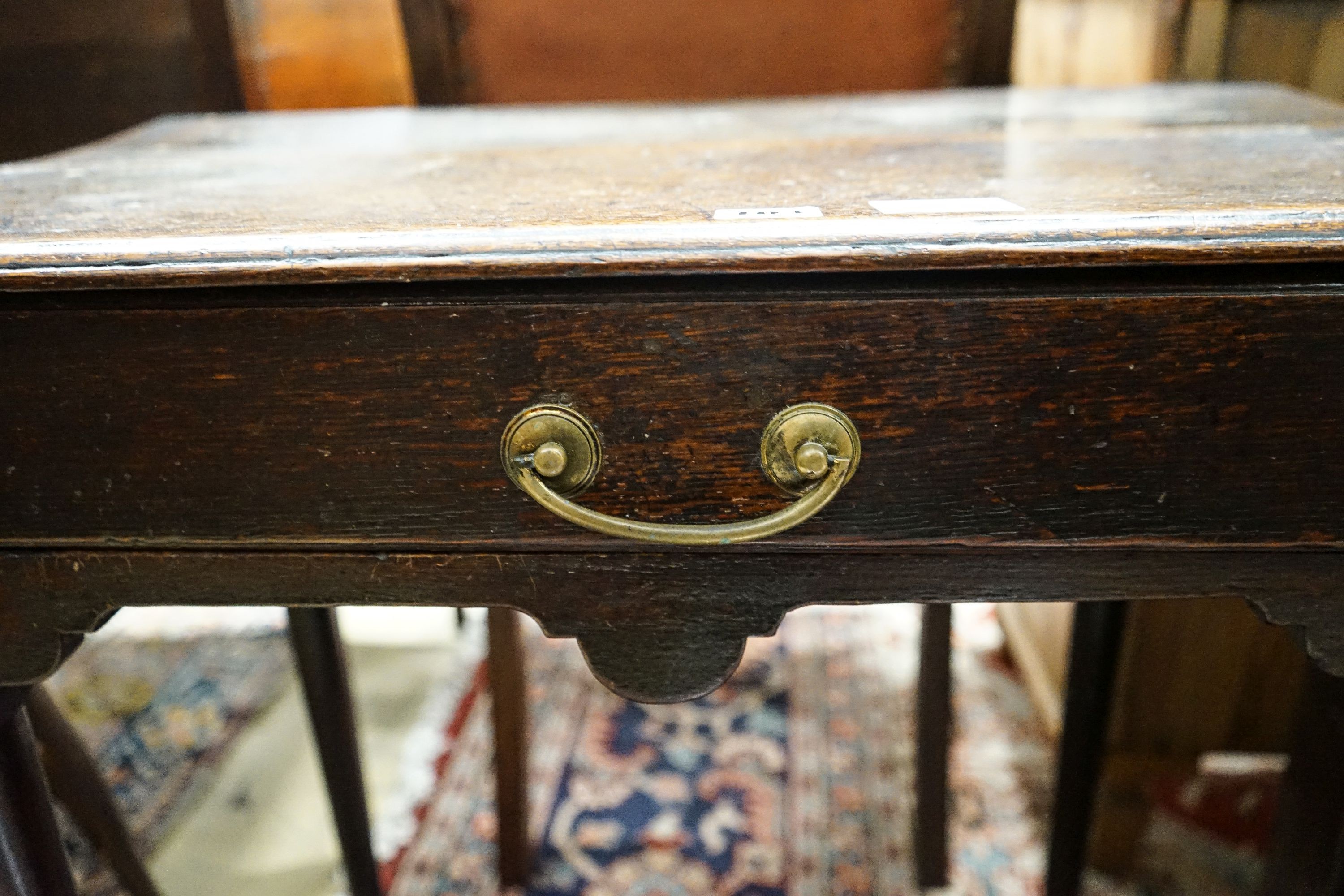 An early 18th century oak lowboy, with single drawer on slender turned legs with pad feet, width 69cm, depth 40cm, height 68cm